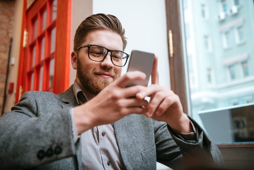 image of American man playing casino games at a mobile casino - mobile casinos